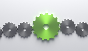 Silver gears with one lime green gear in the middle