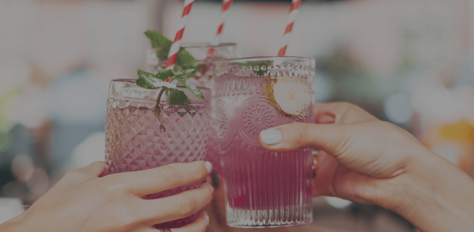 three women celebrating with summer cocktails