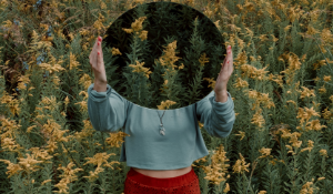 woman in flower field hiding her face with oval shape