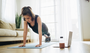 woman doing home workout from living room